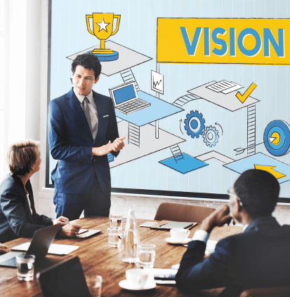 A man in a suit stands confidently before a board displaying the word "Vision," symbolizing leadership and strategic planning.